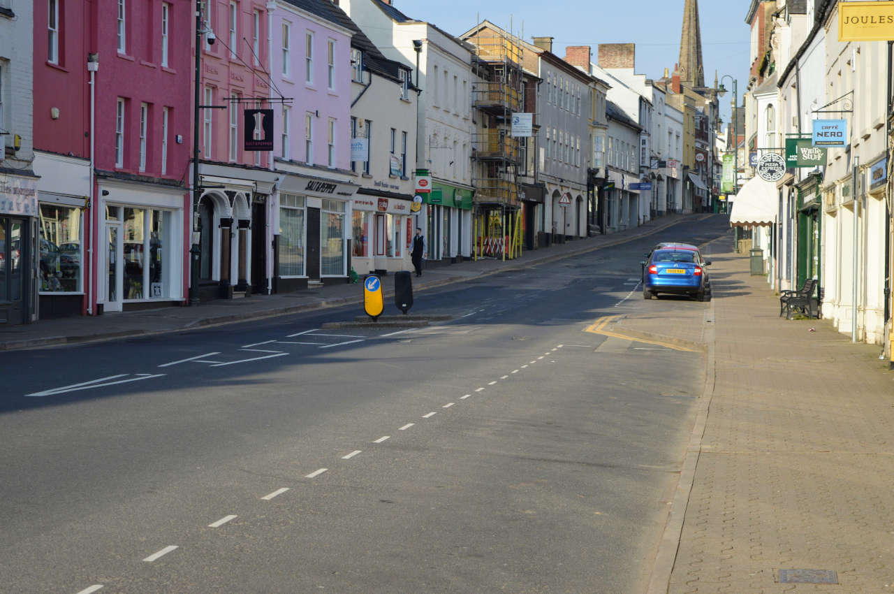 An empty high street in the middle of the day.